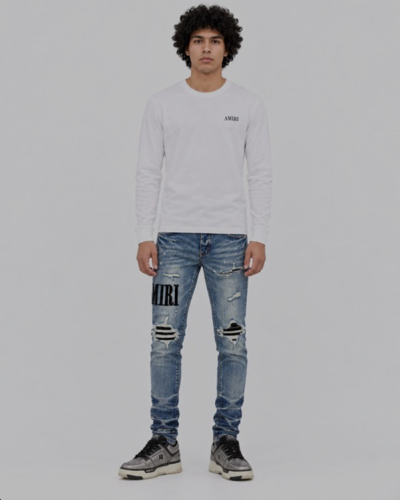 AMIRI Light Indigo & Black Core Appliqué Logo Jeans.