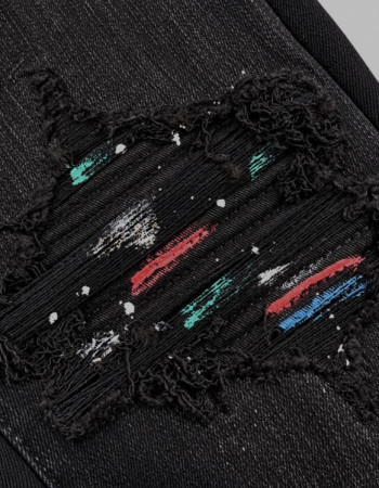 AMIRI Aged Black Paint Splatter MX1 Jeans.