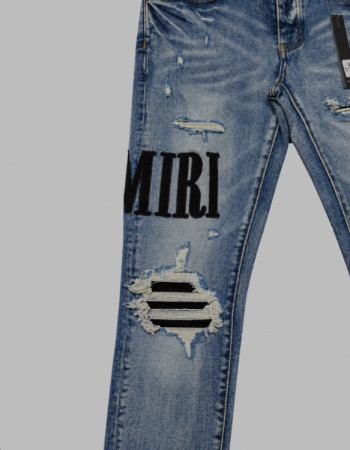 AMIRI Light Indigo & Black Core Appliqué Logo Jeans.