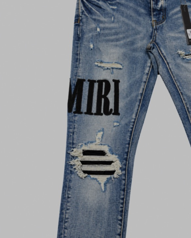AMIRI Light Indigo & Black Core Appliqué Logo Jeans.