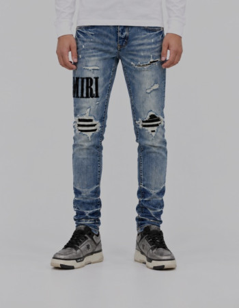 AMIRI Light Indigo & Black Core Appliqué Logo Jeans.