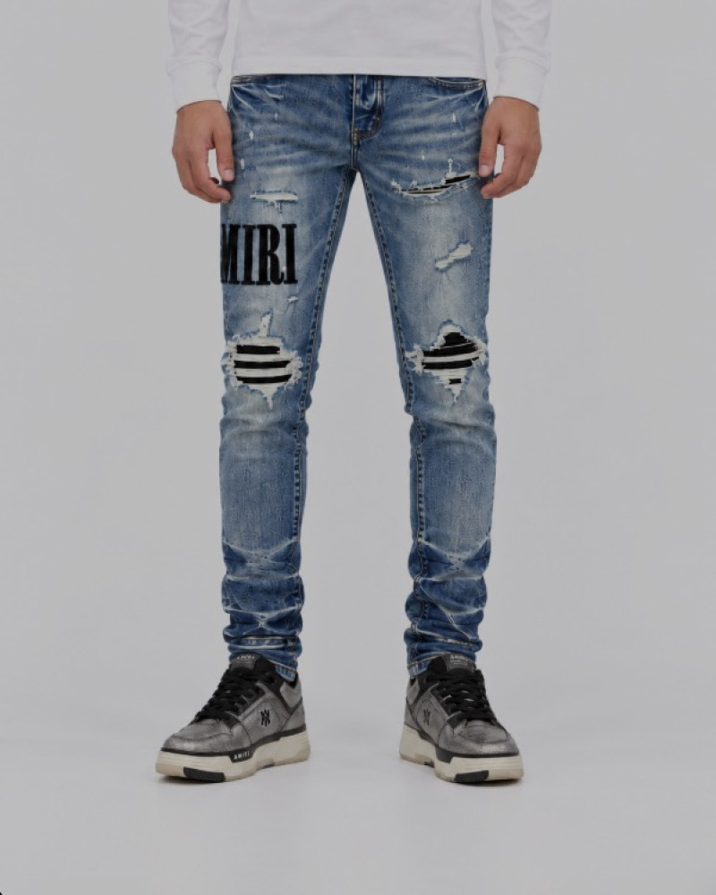 AMIRI Light Indigo & Black Core Appliqué Logo Jeans.