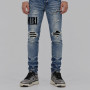 AMIRI Light Indigo & Black Core Appliqué Logo Jeans.