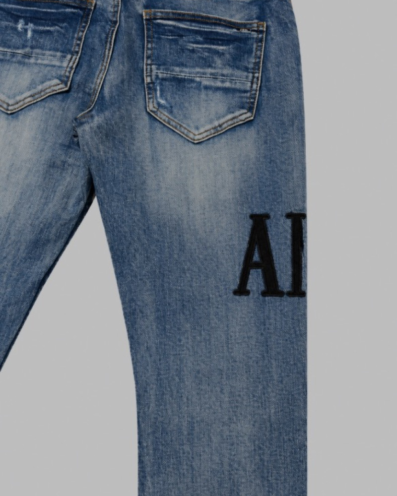 AMIRI Light Indigo & Black Core Appliqué Logo Jeans.